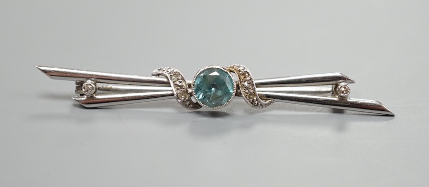 A 14ct white gold, blue zircon and diamond chip set bar brooch